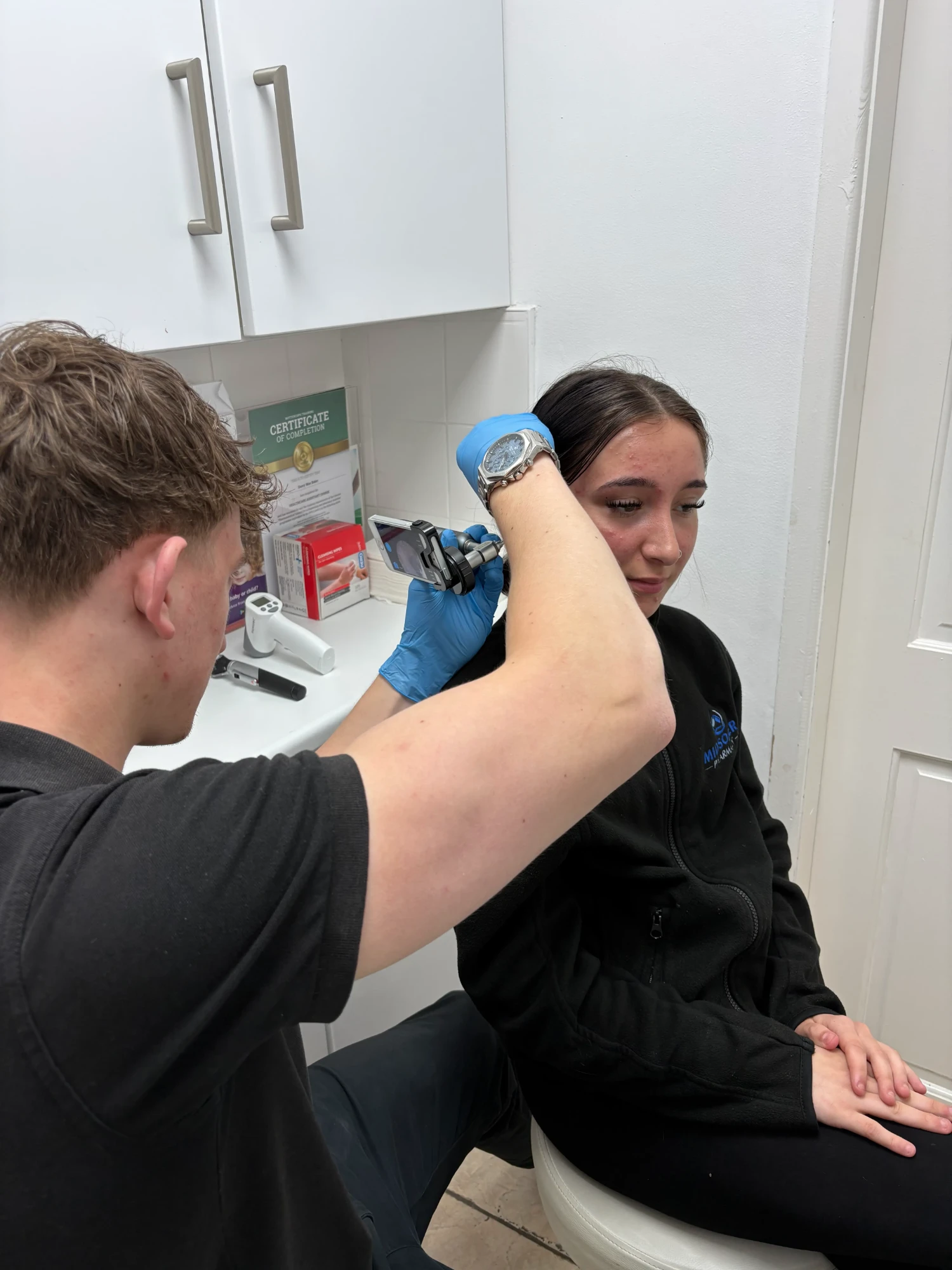 Specialist performing professional microsuction earwax removal